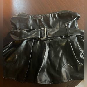 Pleather strapless top with belt accent.